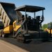 Asphalt paving machinery laying smooth road surface for efficient construction operations