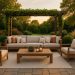 Modern outdoor living room with stylish furniture, cozy lighting, and lush greenery on a patio