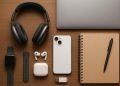 Laptop, wireless headphones, and smart backpack on a desk for university student productivity
