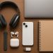 Laptop, wireless headphones, and smart backpack on a desk for university student productivity